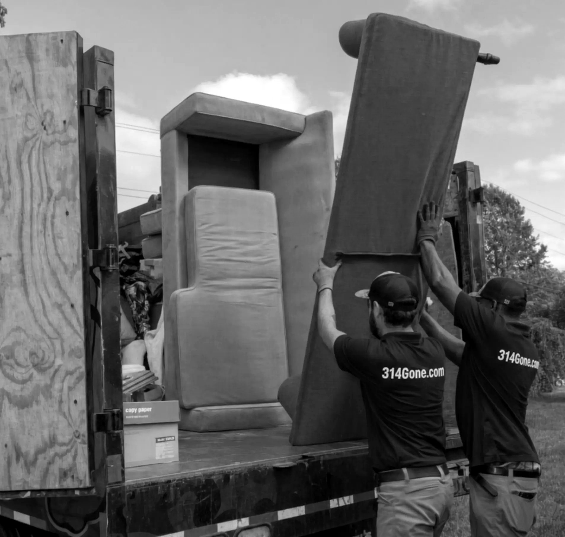 314Gone crew loading junk into the truck