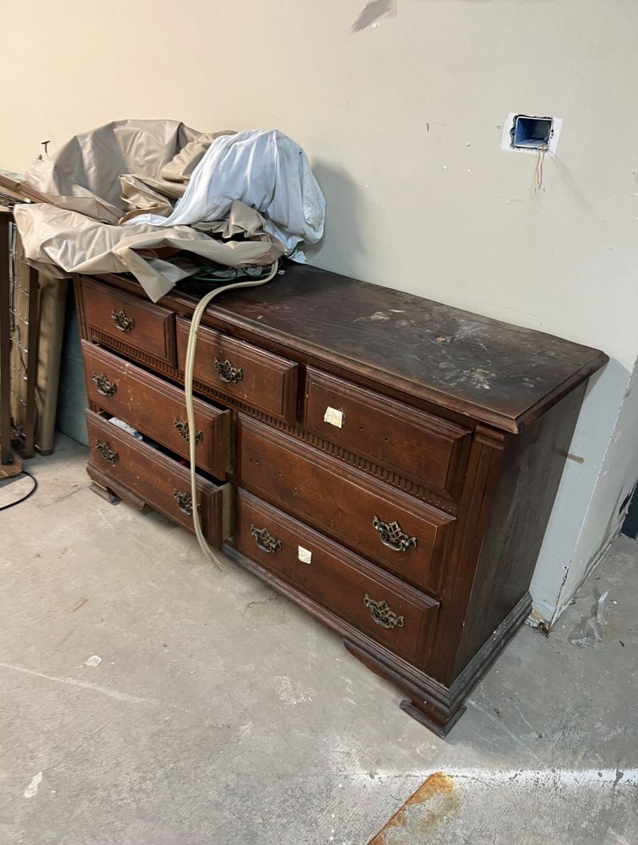 Old dresser and furniture pieces ready for removal